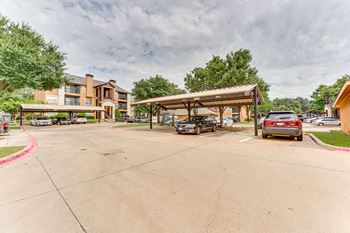 Covered carport parking with residential buildings